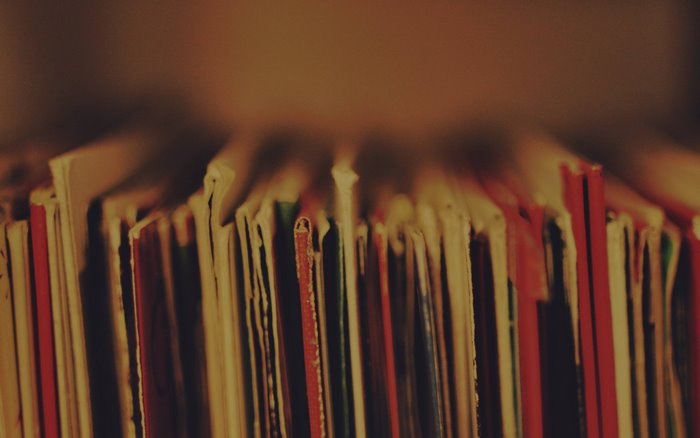 Close-up of vinyl record album covers on a shelf