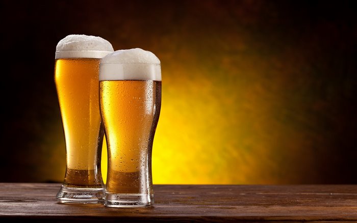 Two glasses of beer with foam