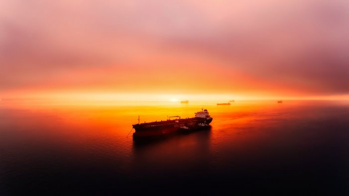 Oil tanker at sunset over the sea