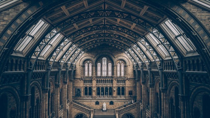Interior of a grand museum with arched ceiling and stairs