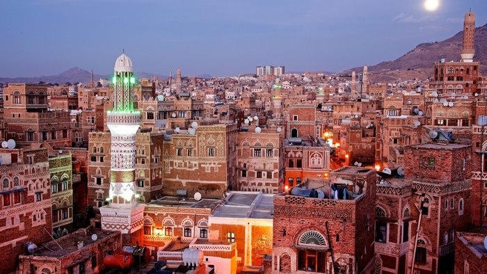 Cityscape of Sana'a, Yemen at dusk with moon