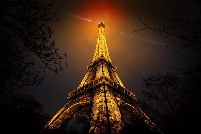Eiffel Tower at night with red and gold lights