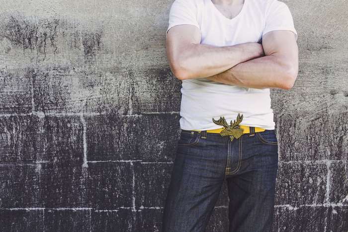 Man in jeans and white t-shirt with moose belt buckle