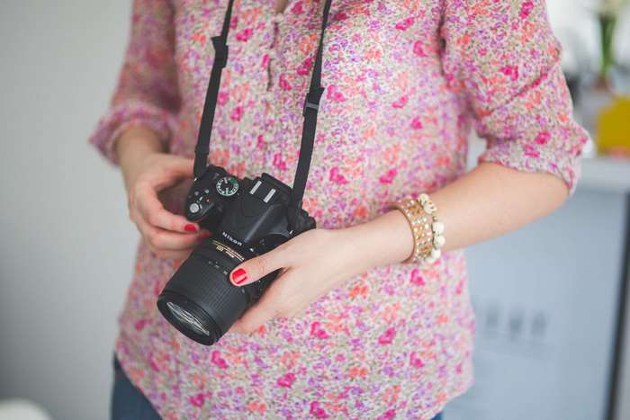 Woman holding a Nikon DSLR camera