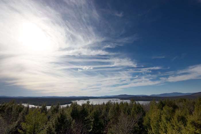 Landscape with lake and forest under a cloudy sky