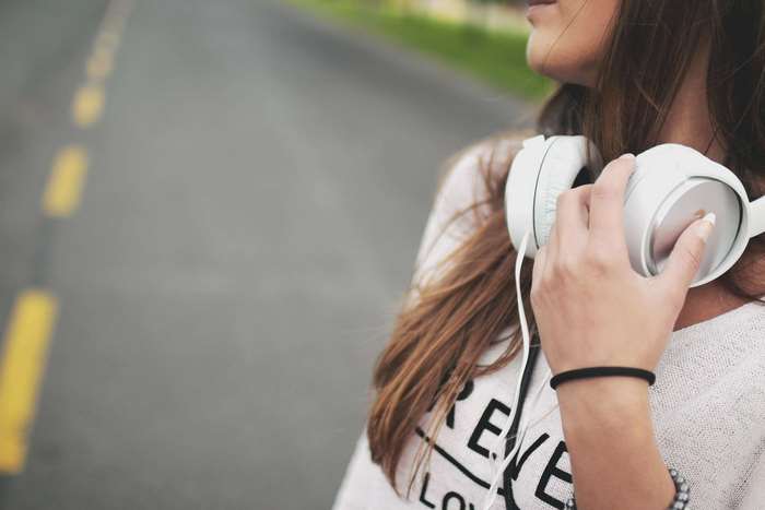 Woman with headphones on a road