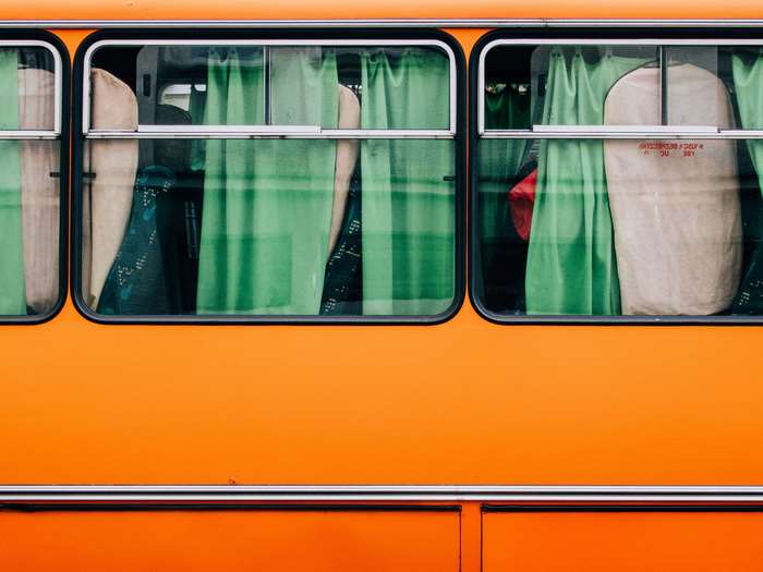 Orange bus windows with green curtains