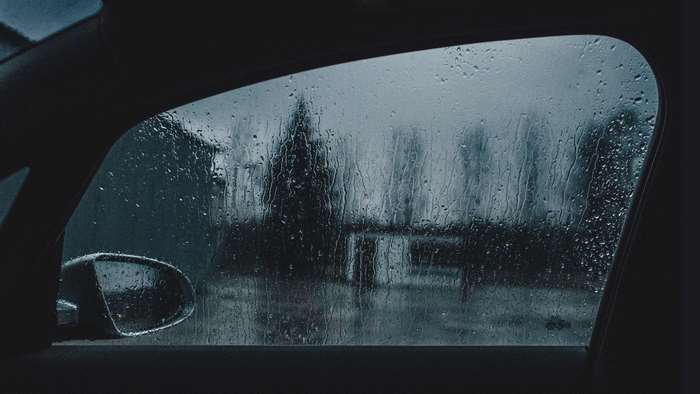 Car window with rain and side mirror