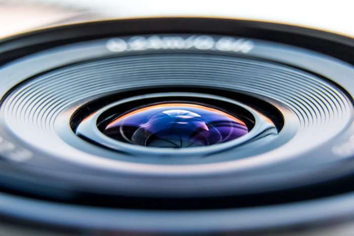 Close-up of a camera lens with reflections