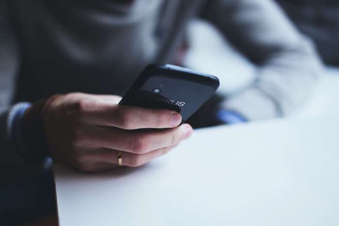 Person holding a Google Nexus smartphone