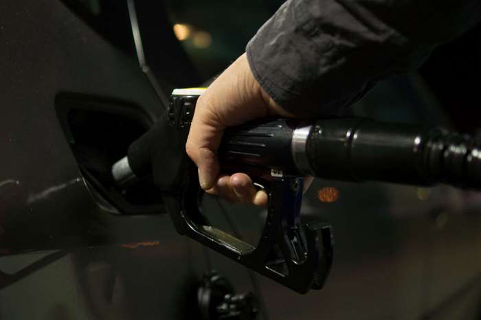 Person fueling a car at a gas station