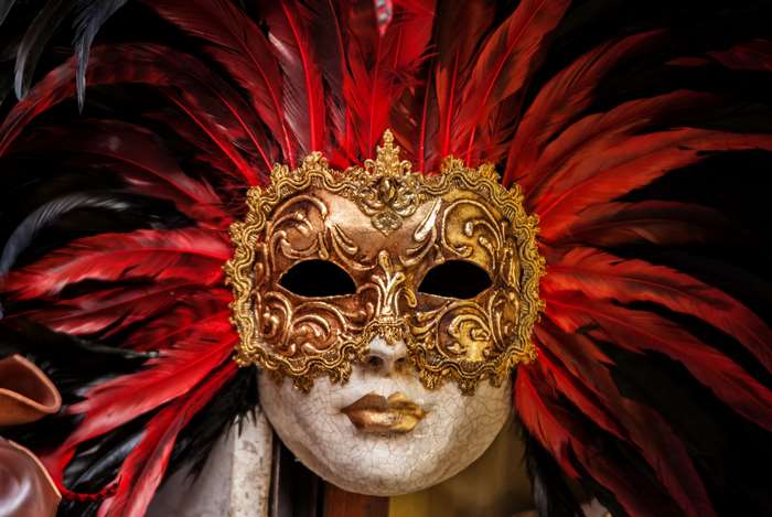 Golden Venetian mask with red feathers