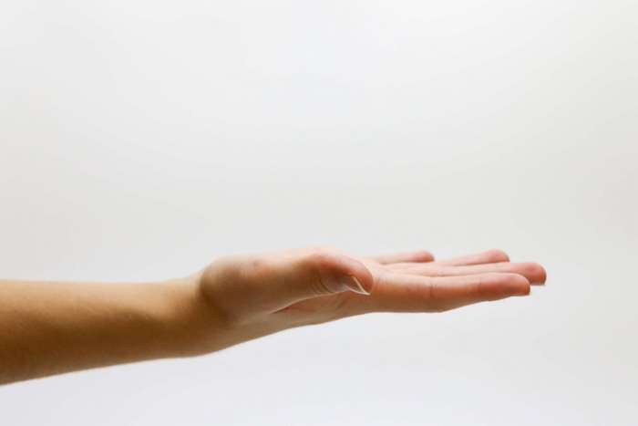 Hand with palm open on white background