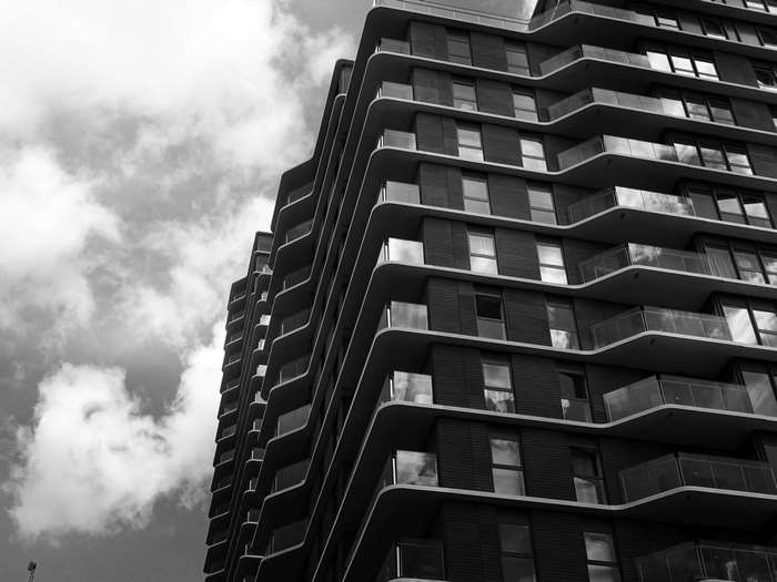 Modern building with balconies against cloudy sky