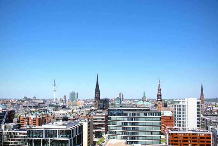 Hamburg skyline with modern and historic buildings under blue sky