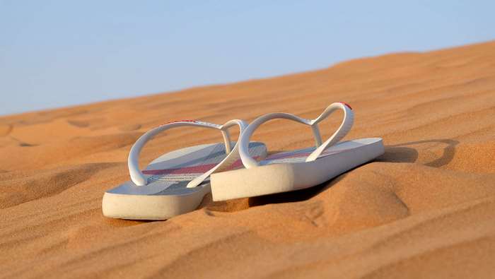 Flip flops on a sand dune