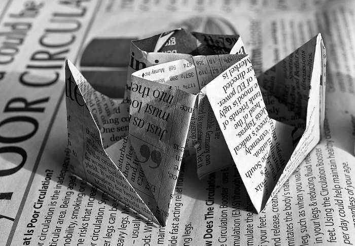 Origami boats on newspaper