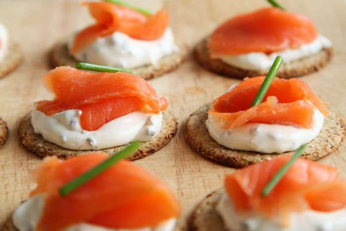 Salmon and cream cheese appetizers on crackers