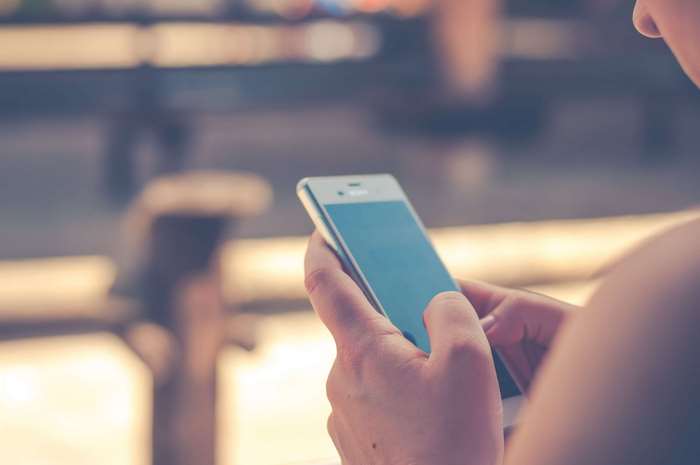 Person holding a smartphone in their hands