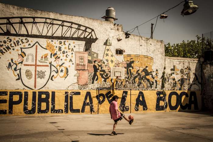 Girl playing soccer in La Boca, Argentina