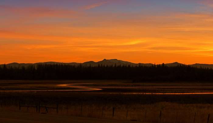 Sunset over Marble Range mountains and river in British Columbia