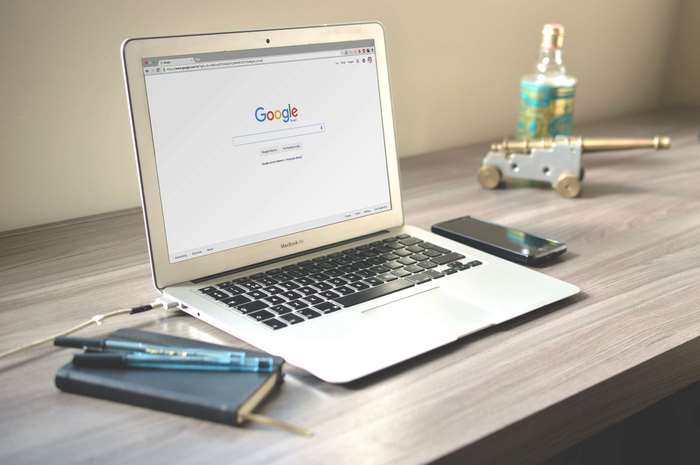 MacBook Air with Google search page on a desk