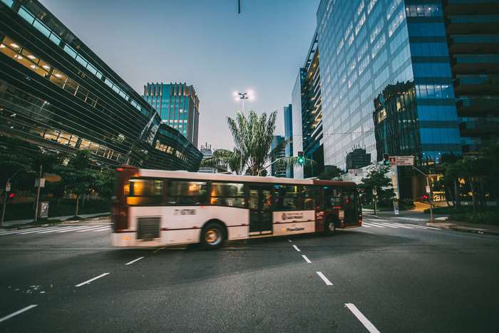 Bus on a city street with modern buildings