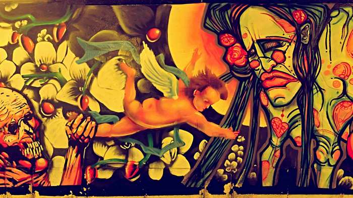 Mural with angel, skull, and face in Gdansk