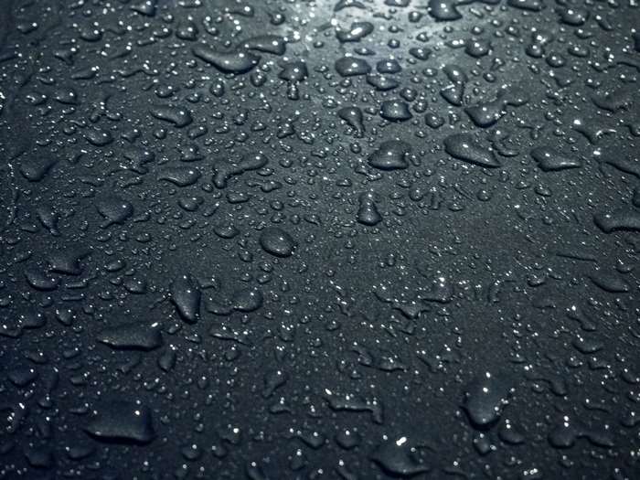 Close up of water droplets on a dark surface