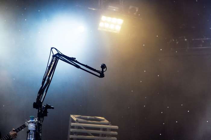 Microphone boom on a concert stage with lights