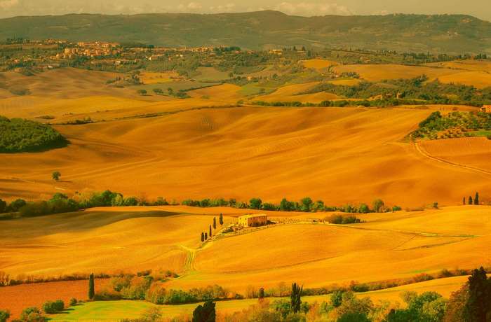Tuscan landscape with rolling hills and a farmhouse