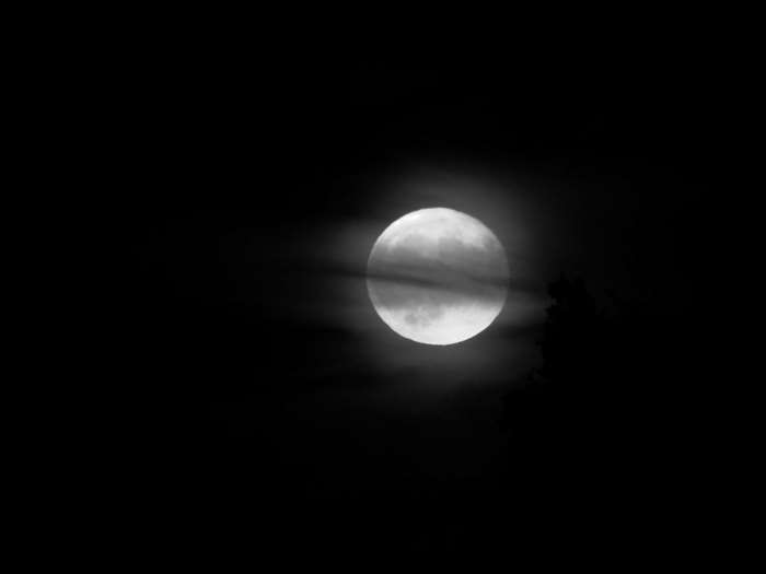 Full moon behind clouds