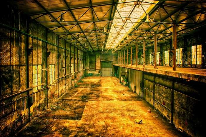 Abandoned industrial factory hall with skylights and decay