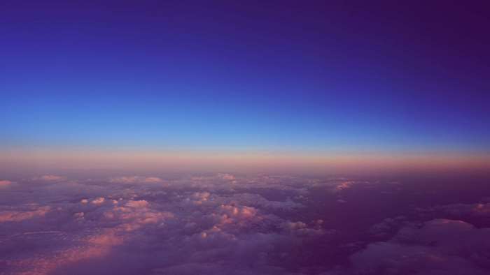 Sunset over clouds from airplane window