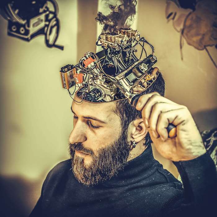 Man with mechanical brain and smoking engine
