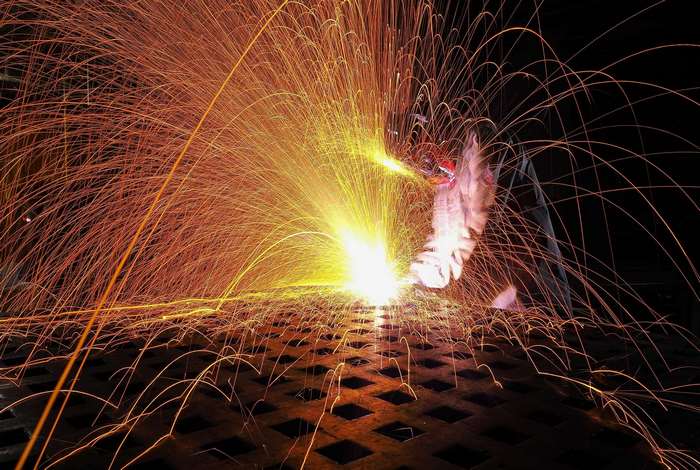 Welder working with sparks flying
