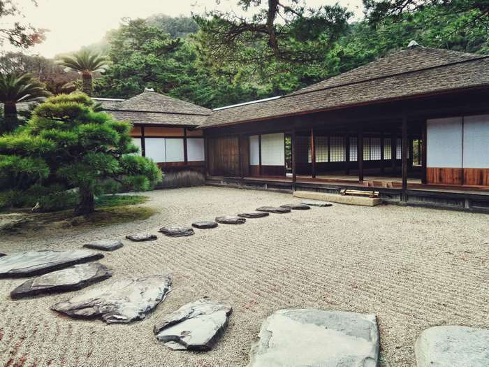Japanese garden with traditional house and stone path