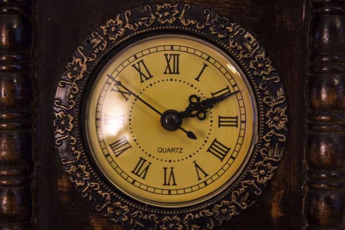 Vintage wooden alarm clock with Roman numerals