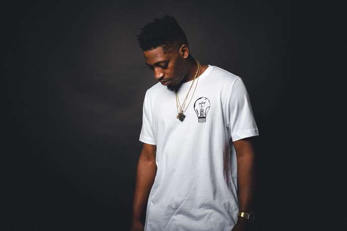 Man wearing a white t-shirt with a lightbulb print