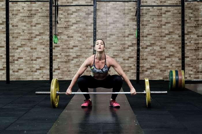 Woman Lifting Barbell in Gym 4K