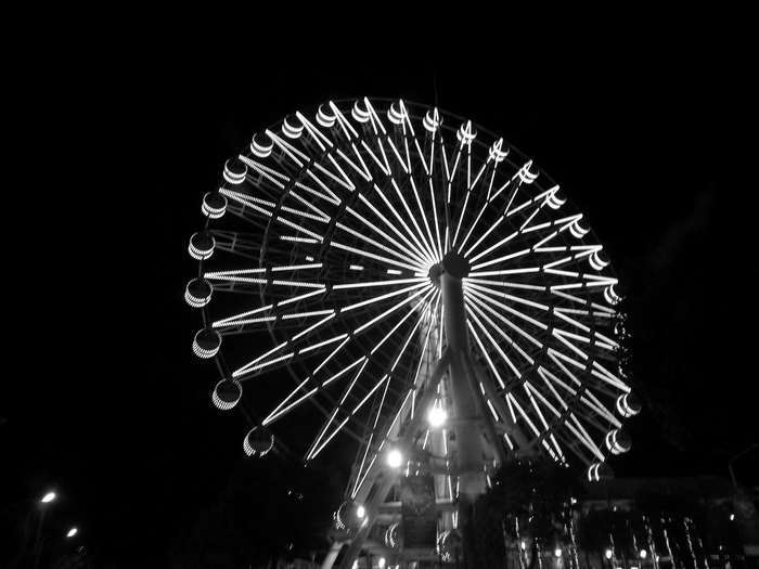Black and white Ferris wheel at night