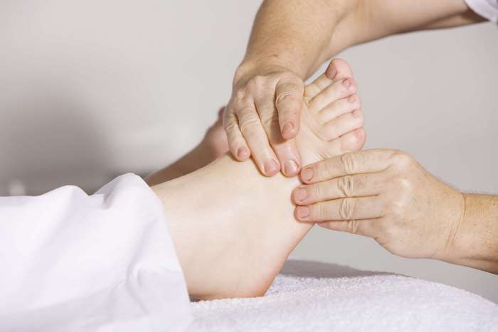 Foot massage therapy with hands