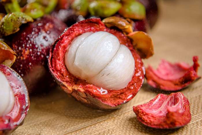 Mangosteen fruit on a textured surface