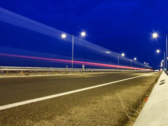 Highway at night with light trails and street lights