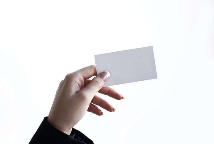 Woman holding a blank business card