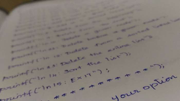 Handwritten code on paper