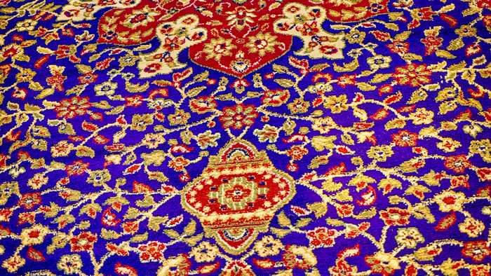 Persian floral pattern carpet with red and golden yellow design