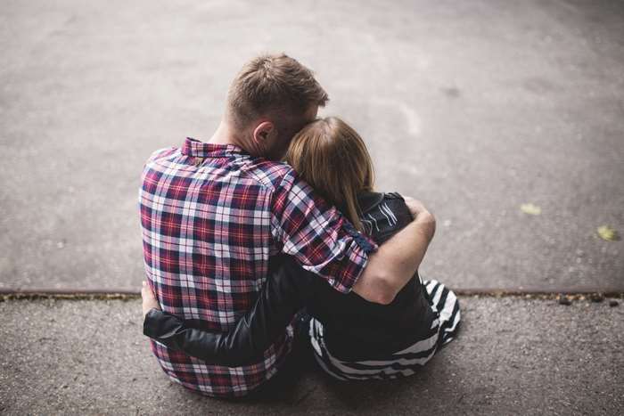 Man and woman hugging outdoors