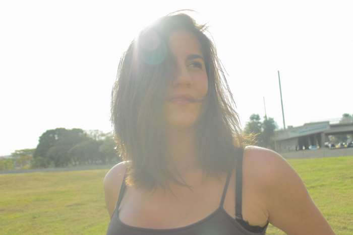 Woman in a black tank top in a park