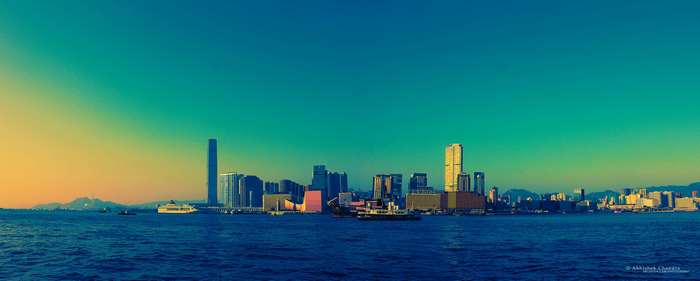 Hong Kong skyline across the ocean at sunset 4K
